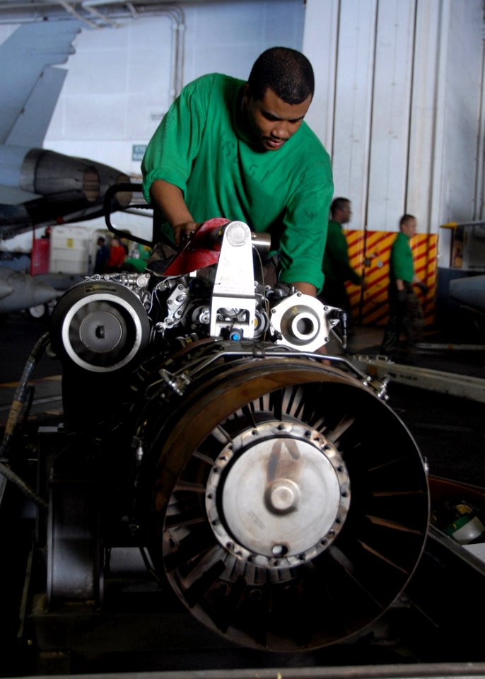 US Navy 091107-N-1644H-064 Aviation Machinist Mate 2nd Class Steven Lawrence, assigned to the Warlords of Helicopter Anti-Submarine Squadron Light (HSL) 51, replaces a T700-401C engine inside an SH-60B Sea Hawk helicopter