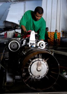 US Navy 091107-N-1644H-064 Aviation Machinist Mate 2nd Class Steven Lawrence, assigned to the Warlords of Helicopter Anti-Submarine Squadron Light (HSL) 51, replaces a T700-401C engine inside an SH-60B Sea Hawk helicopter