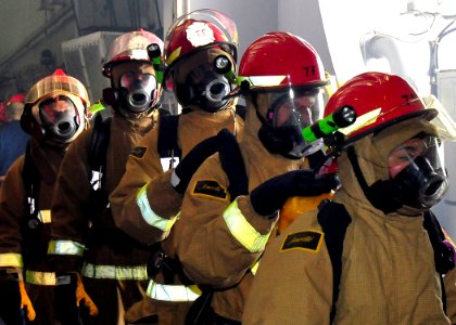 US Navy 091110-N-1062H-013 ailors walk through a smoke filled space during a general quarters drill aboard the aircraft carrier USS George Washington (CVN 73)
