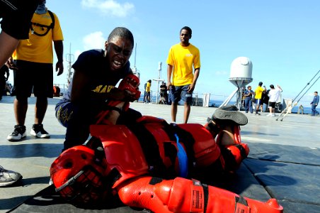 US Navy 091111-N-7280V-673 Boatswain's Mate Seaman Lashaunda Foster demonstrates force protection techniques after getting sprayed with Oleoresin Capsicum during a security reactionary force, non-lethal weapons class