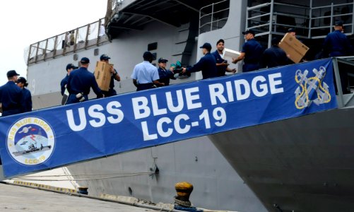 US Navy 091107-N-7478G-552 Sailors assigned to the amphibious command ship USS Blue Ridge (LCC 19) offload boxes of humanitarian supplies donated from Project Handclasp photo