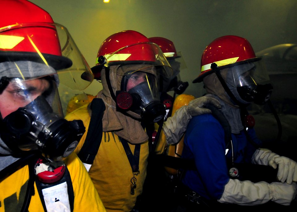 US Navy 091112-N-1062H-019 Sailors aboard the aircraft carrier USS George Washington (CVN 73) fight a simulated fire during a general quarters drill