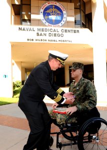 US Navy 091107-N-6326B-031 Capt. Ted J. Lucas, commodore, Explosive Ordnance Disposal Group 1, presents the Purple Heart medal to Staff Sgt. Jesse A. Cottle at Naval Medical Center San Diego