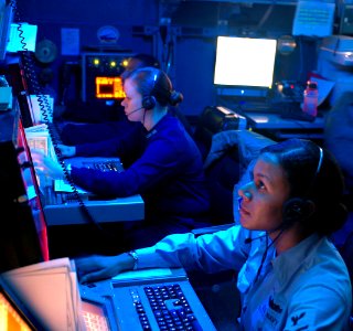 US Navy 091108-N-8960W-020 Operations Specialists track air contacts from the Combat Direction Center aboard the aircraft carrier USS Nimitz (CVN 68) photo