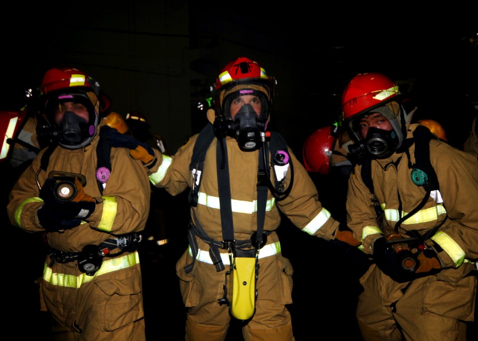 US Navy 091110-N-7282P-029 ailors simulate fighting a fire during a general quarters drill in the hangar bay aboard the aircraft carrier USS George Washington (CVN 73). George Washington, the Navy's only permanently forward-dep