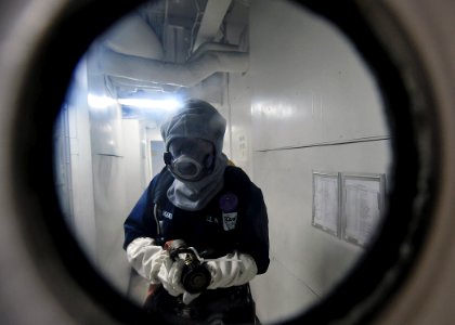 US Navy 091112-N-1062H-023 Mass Communication Specialist Seaman Apprentice Marcos Vazquez mans a hose at the primary fire boundary during a general quarters drill aboard the aircraft carrier USS George Washington (CVN 73)