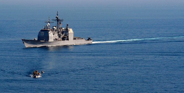US Navy 091108-N-9500T-037 The guided-missile cruiser USS Chosin (CG 65) maneuvers past a fishing dhow in the Gulf of Aden while conducting counter-piracy operations
