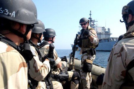 US Navy 091109-N-0260R-018 Machinery Technician 2nd Class Jason Taylor, assigned to U.S. Coast Guard Maritime Security and Safety Team Galveston 91104, briefs members of a visit, board, search, and seizure team from the guided photo