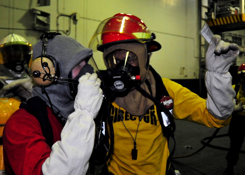 US Navy 091112-N-1062H-004 Aviation Boatswain's Mate (Handling) 3rd Class Jason Querido relays messages to Aviation Boatswain's Mate (Handling) Airman Robert Page to relay back to Damage Control Central during a general quarter