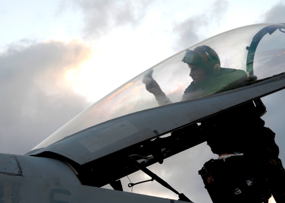 US Navy 091114-N-2456S-018 Aviation Structural Mechanic Airman Jesse Florez, assigned to the Wildcats of Strike Fighter Squadron (VFA) 131, wipes down the canopy of an F-A-18C