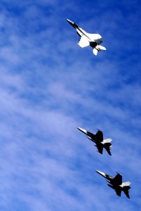 US Navy 091109-N-9928E-133 An F-A-18E Super Hornet assigned to the Argonauts of Strike Fighter Squadron (VFA) 147 breaks away from the formation over the Nimitz-class aircraft carrier USS John C. Stennis (CVN 74)