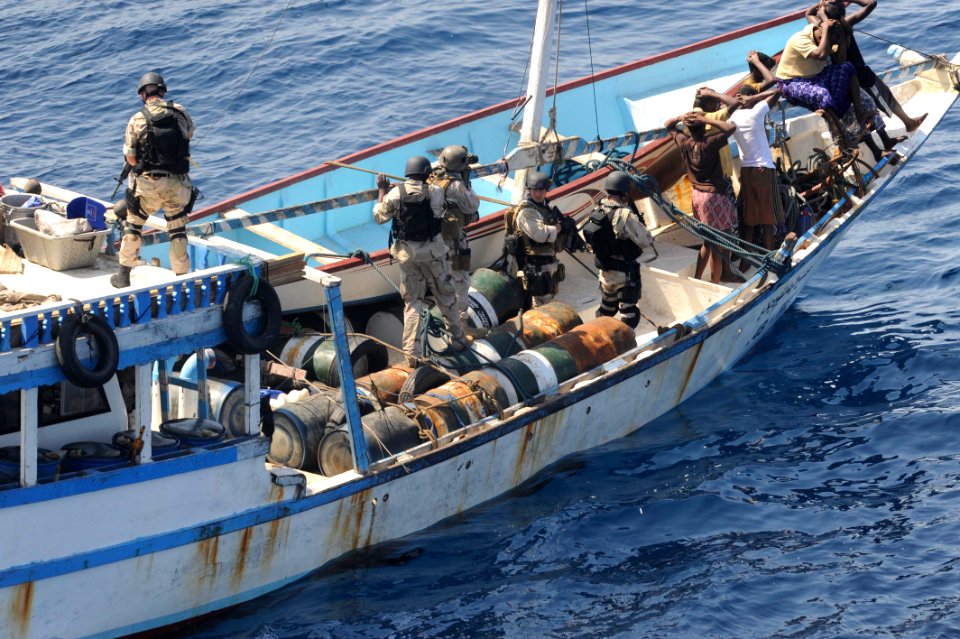 US Navy 091112-N-9500T-170 Members of a visit, board, search and seizure team from the guided-missile cruiser USS Chosin (CG 65) keep watch over the crew of a suspected pirate dhow