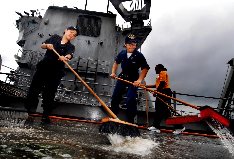 US Navy 091113-N-0807W-327 Sailors aboard USS Harpers Ferry (LSD 49) scrub the weather decks during an aqueous film forming foam countermeasure wash down