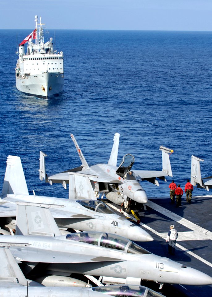 US Navy 091115-N-4954I-002 A group of Aviation Ordnancemen from the Blue Diamonds of Strike Fighter Squadron (VFA) 146, walk to the aft end of the flight deck to watch the Canadian navy logistics vessel HMCS Protecteur