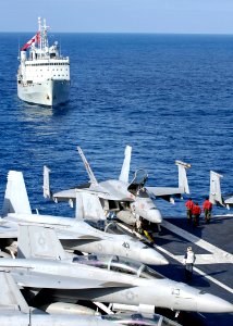US Navy 091115-N-4954I-002 A group of Aviation Ordnancemen from the Blue Diamonds of Strike Fighter Squadron (VFA) 146, walk to the aft end of the flight deck to watch the Canadian navy logistics vessel HMCS Protecteur