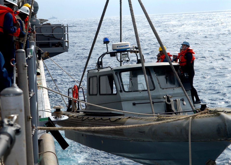 US Navy 091116-N-6692A-013 Sailors lower a rigid hull inflatable boat to be used as a ready lifeboat during a visit, board, search and seizure training exercise aboard the amphibious dock landing ship USS Tortuga (LSD 46)