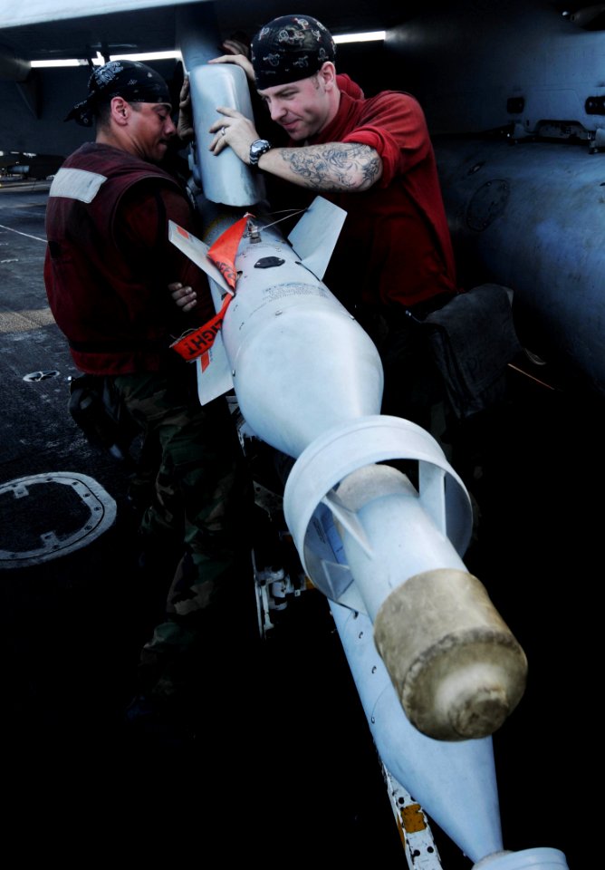 US Navy 091112-N-3038W-352 Aviation Ordnancemen upload a laser-guided bomb to an F-A-18C Hornet