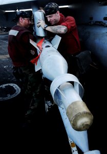 US Navy 091112-N-3038W-352 Aviation Ordnancemen upload a laser-guided bomb to an F-A-18C Hornet photo