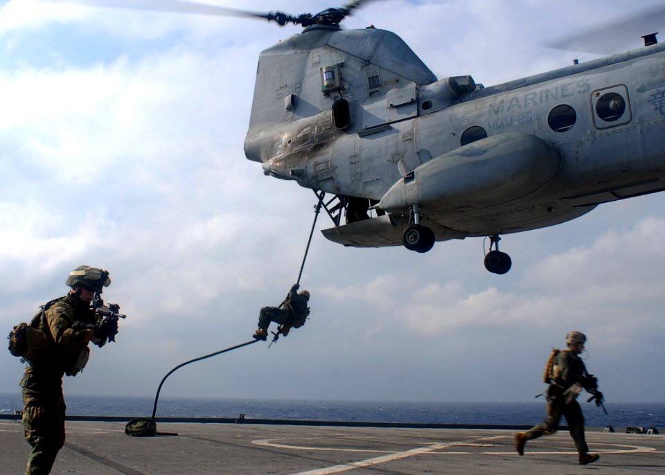 US Navy 091116-N-6692A-034 Marines from the 31st Marine Expeditionary Unit (31st MEU) fast-rope from a CH-46 Sea Knight helicopter during visit, board, search and seizure training exercise