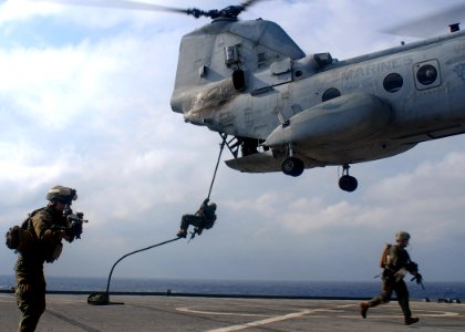 US Navy 091116-N-6692A-034 Marines from the 31st Marine Expeditionary Unit (31st MEU) fast-rope from a CH-46 Sea Knight helicopter during visit, board, search and seizure training exercise