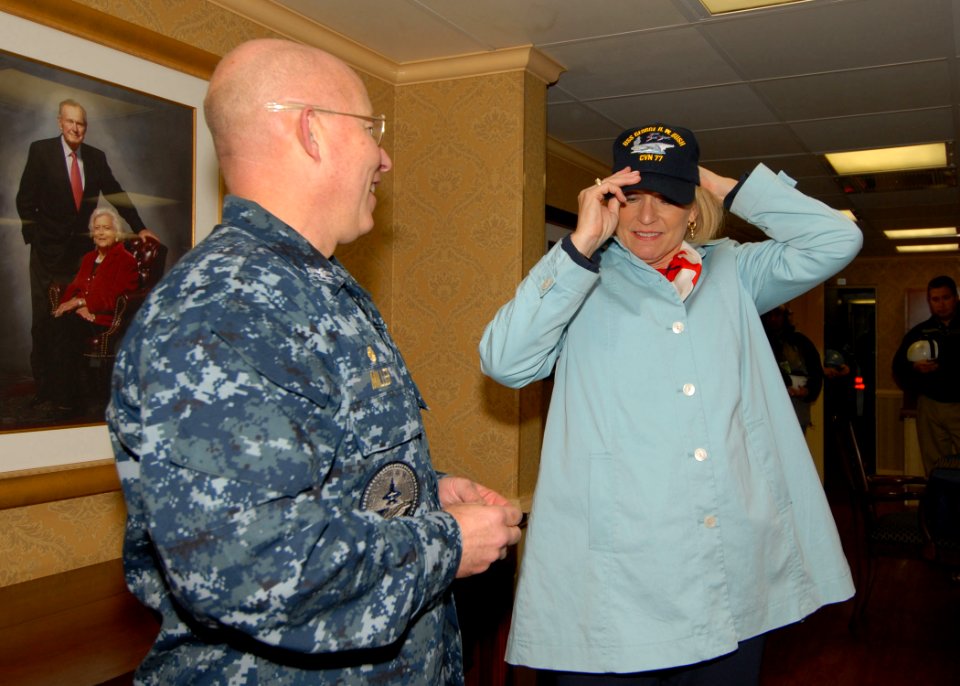 US Navy 091113-N-8560K-057 Capt. Chip Miller, commanding officer of the aircraft carrier USS George H.W. Bush (CVN 77), presents a command ball cap to Susan Ford Bales