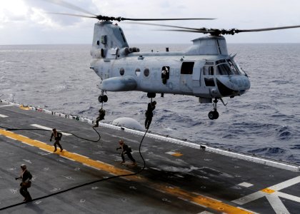 US Navy 091114-N-0120A-187 Marines assigned to the 31st Marine Expedition Unit (31st MEU) embarked aboard the USS Essex (LHD 2) conduct fast rope training from a CH-46E Sea Knight photo