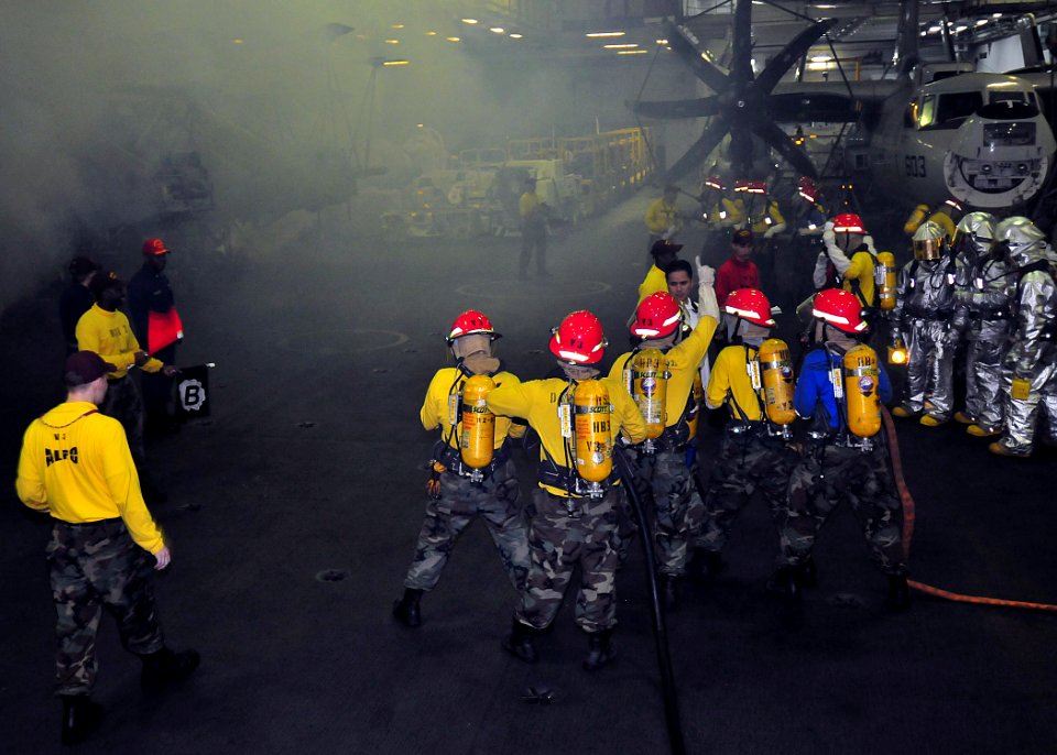 US Navy 091112-N-1062H-006 Sailors aboard the aircraft carrier USS George Washington (CVN 73) fight a simulated fire during a general quarters drill