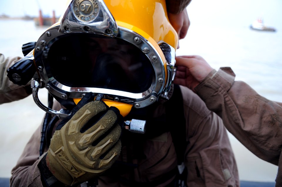 US Navy 091116-N-4154B-265 Navy Diver 1st Class Daniel Muhlbach completes his final pre-dive checks before diving down to secure a set of lifting wires to a sunken barge