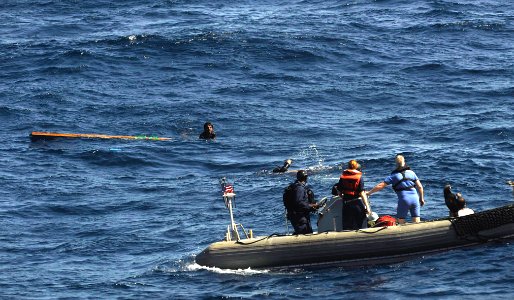 US Navy 091117-N-9500T-272 Search and Rescue Swimmer Gas Turbine Systems Mechanic 2nd Class Alfredo Rodriguez swims toward the last of three men clinging to a piece of wood in the Gulf of Aden