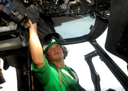 US Navy 091116-N-8607R-053 Aviation Electronics Technician 2nd Class Jonathan Zoucha, from Shelby, Neb. and assigned to Helicopter Sea Combat Squadron (HSC) 23, checks cockpit systems