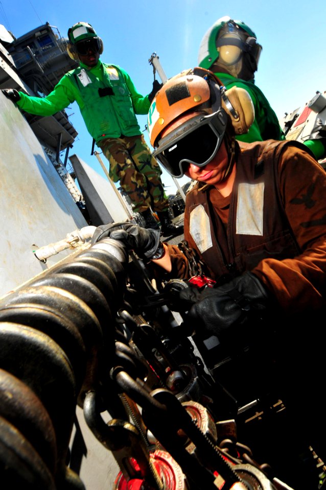 US Navy 091118-N-4053P-025 Aviation Electronics Technician 3rd Class Richard Genavieve re-stows chains aboard USS Nimitz (CVN 68)
