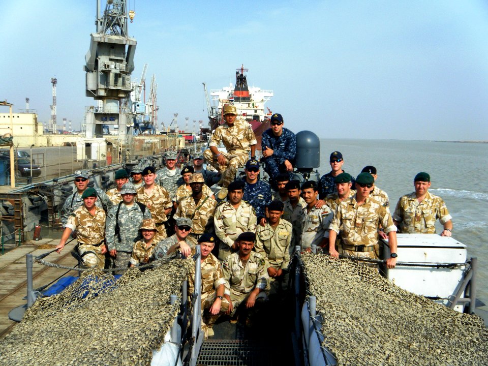 US Navy 091114-N-0000X-003 Members of Mobile Diving and Salvage Unit (MDSU) 2, the Royal Navy and members of the Iraqi Defense Forces pose for a photo aboard the coastal patrol boat USS Firebolt (PC 10)