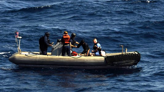 US Navy 091117-N-9500T-312 The last of three men that were clinging to a piece of wood in the Gulf of Aden is helped aboard a rigid hull inflatable boat