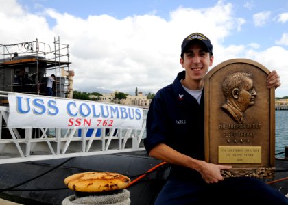 US Navy 091117-N-3560G-005 Junior Sailor of the Quarter Electrician's Mate 2nd Class Cole Parks displays the Arleigh Burke Trophy