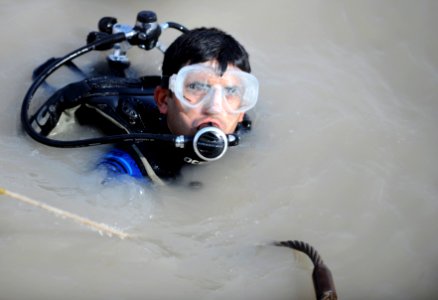 US Navy 091115-N-4154B-184 A diver from an Iraqi Navy Dive Team receives instructions to deliver a cable to another diver during diving operations photo