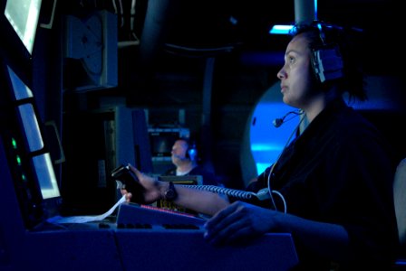 US Navy 091119-N-7058E-250 Fire Controlman 1st Class Ronila Ivory prepares to fire the ship's Mk-110 57mm gun from the mission control center