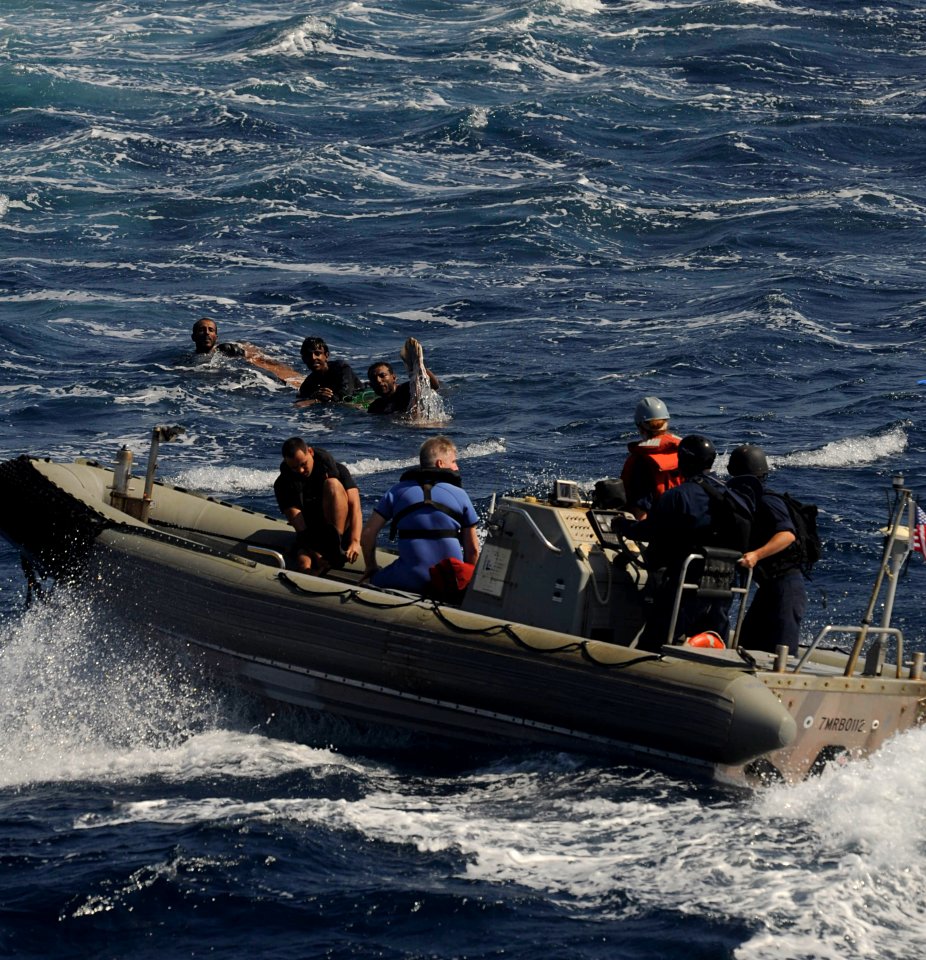 US Navy 091117-N-9500T-219 A boat crew from USS Chosin (CG 65) approaches three men that were spotted clinging to a piece of wood in the Gulf of Aden