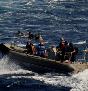 US Navy 091117-N-9500T-219 A boat crew from USS Chosin (CG 65) approaches three men that were spotted clinging to a piece of wood in the Gulf of Aden