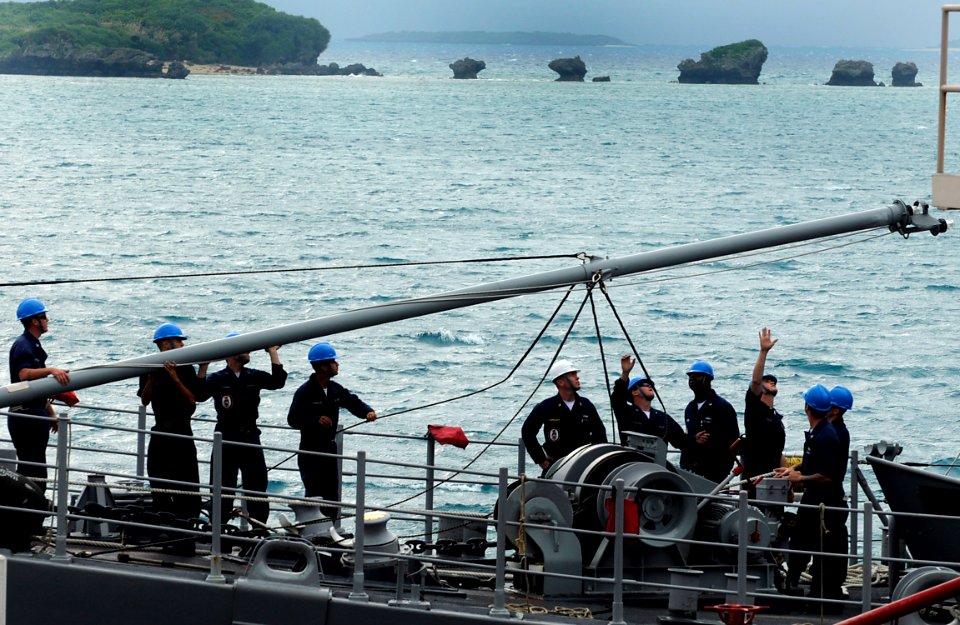 US Navy 091116-N-7280V-053 Sailors aboard the mine countermeasures ship USS Defender (MCM 2) perform scheduled preventive maintenance on the light bulbs on the jack staff while in port