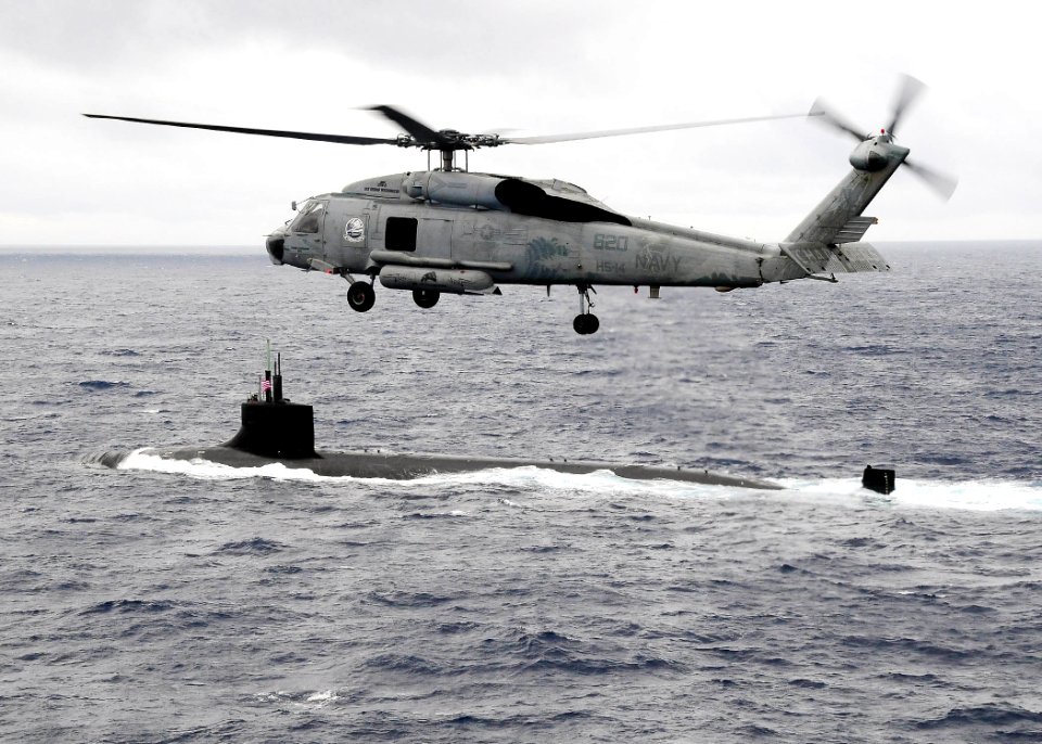 US Navy 091117-N-1644H-117 An HH-60H Sea Hawk helicopter from the Chargers of Helicopter Anti-Submarine Squadron (HS) 14 flies over the Seawolf-class attack submarine USS Connecticut (SSN 22)