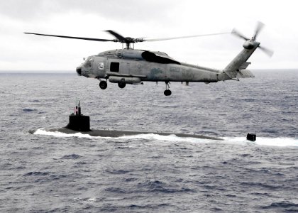 US Navy 091117-N-1644H-117 An HH-60H Sea Hawk helicopter from the Chargers of Helicopter Anti-Submarine Squadron (HS) 14 flies over the Seawolf-class attack submarine USS Connecticut (SSN 22)