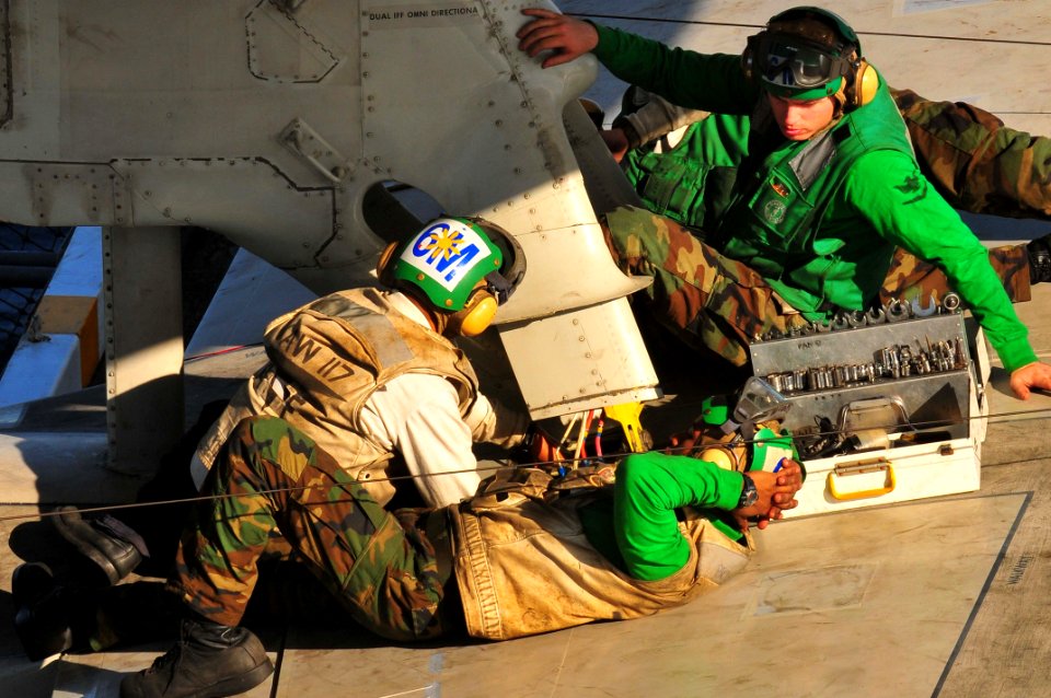 US Navy 091116-N-4053P-008 Members assigned to the Wallbangers of Airborne Early Warning Squadron (VAW) 117 make repairs and adjustments to the radar on the flight deck of the aircraft carrier USS Nimitz(CVN 68)