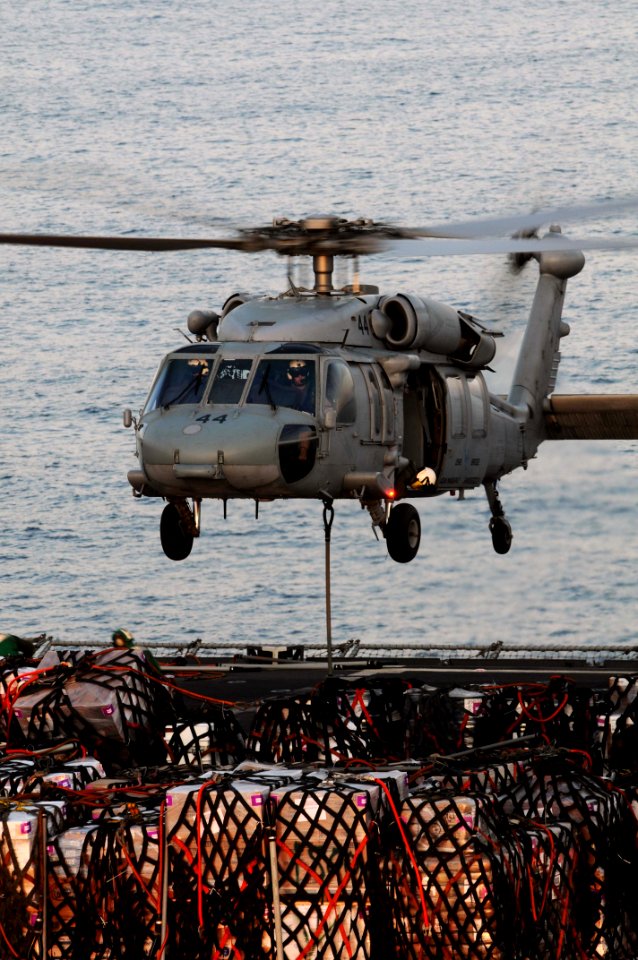 US Navy 091119-N-3038W-086 An MH-60S Sea Hawk helicopter assigned to the Wildcards of Helicopter Sea Combat Squadron (HSC) 23 lifts supplies from the flight deck of the Military Sealift Command fast combat support ship USNS Bri