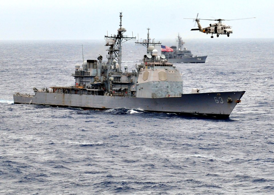 US Navy 091117-N-4010S-186 A Japan Maritime Self-Defense Force Mitsubishi SH-60J Sea Hawk helicopter flies over the guided-missile cruiser USS Cowpens (CG 63) during Annual Exercise (ANNUALEX 21G)