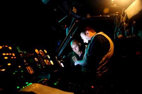 US Navy 091122-N-9500T-223 Aviation Electrician's Mate 3rd Class Adam Cook, right, and Aviation Structural Mechanic 3rd Class Oran Hill troubleshoot an electrical fault on an SH-60B Sea Hawk helicopter