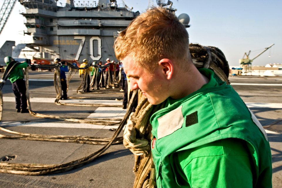 US Navy 091117-N-2953W-009 Interior Communications Electrician 2nd Class Shawn Magoon tows barricade webbing