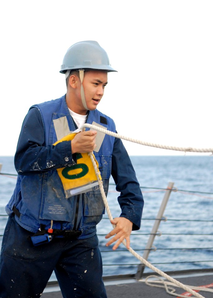 US Navy 091116-N-9520G-064 Logistic Specialist 3rd Class Charles Edison Rostro, slacks the phone and distance line during an underway replenishment