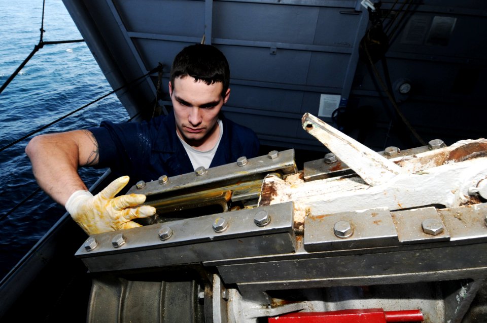 US Navy 091119-N-3038W-235 Seaman David Mahan performs maintenance on a fuel station aboard the aircraft carrier USS Nimitz (CVN 68)