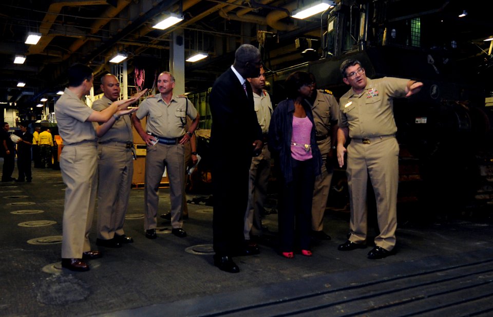 US Navy 091120-N-0890S-091 Capt. Lowell D. Crow, commanding officer of the USS Wasp (LHD 1), conducts a tour of the well deck to distinguished visitors from Jamaica