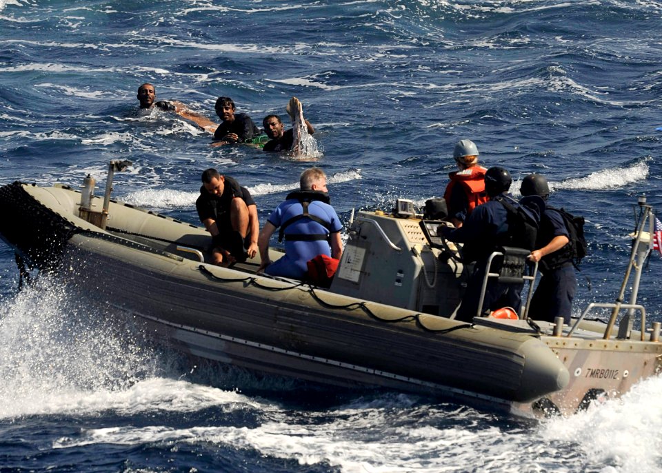 US Navy 091117-N-XXXX0-219 A boat crew from the guided-missile cruiser USS Chosin (CG 65) approaches three men that were spotted clinging to a piece of wood in the Gulf of Aden
